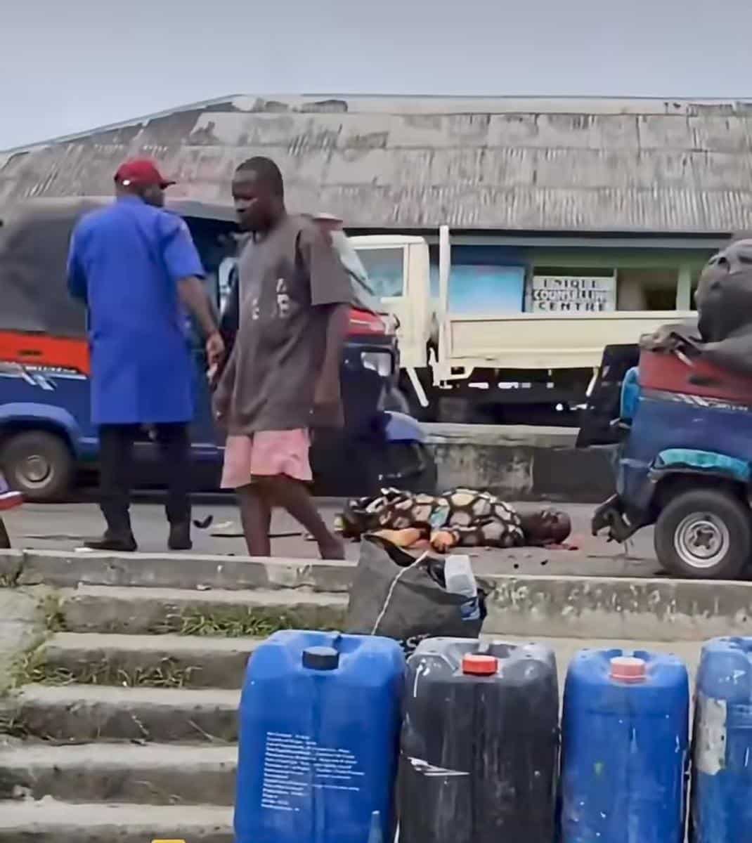 FRSC officers and residents gather after a cement-laden trailer crashed into a commercial tricycle, killing a keke driver in Yenagoa, Bayelsa State.